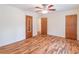 This bedroom features hardwood floors, a ceiling fan, and neutral colored walls at 4077 Phils Ct, Tucker, GA 30084
