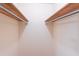 Walk-in closet with wooden shelves and rod, offering organized storage solutions at 4077 Phils Ct, Tucker, GA 30084