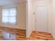 Sun-filled entryway featuring hardwood floors, white trim, and white front door at 4077 Phils Ct, Tucker, GA 30084
