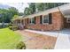 Brick home featuring black shutters, a white railing, and a walkway at 4077 Phils Ct, Tucker, GA 30084