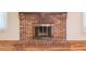 Close up of brick fireplace with hearth and metal screen at 4077 Phils Ct, Tucker, GA 30084