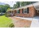 Brick home with manicured lawn, black shutters, and covered entrance at 4077 Phils Ct, Tucker, GA 30084
