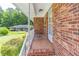 Brick home's tiled front porch featuring a white railing and ample natural light at 4077 Phils Ct, Tucker, GA 30084