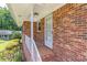 View of a brick front porch with a white railing and an inviting entrance door at 4077 Phils Ct, Tucker, GA 30084