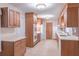 Traditional eat-in kitchen with wooden cabinets, white appliances, and tile flooring at 4077 Phils Ct, Tucker, GA 30084