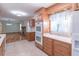 Well-lit kitchen with modern appliances, wooden cabinets, and tiled floor at 4077 Phils Ct, Tucker, GA 30084