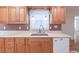 Kitchen sink and counter area with wooden cabinets and backsplash at 4077 Phils Ct, Tucker, GA 30084