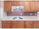 Updated kitchen features custom cabinets, smooth countertops, and a stylish tile backsplash at 4077 Phils Ct, Tucker, GA 30084