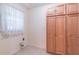 This laundry room includes storage cabinets and a window for natural light at 4077 Phils Ct, Tucker, GA 30084