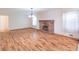 Large living room featuring hardwood floors, brick fireplace, and a view into another room at 4077 Phils Ct, Tucker, GA 30084