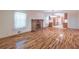 Cozy living room with hardwood floors, traditional fireplace, and a view into the kitchen at 4077 Phils Ct, Tucker, GA 30084