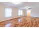 Bright living room featuring hardwood floors, two windows, and ceiling fan for comfort at 4077 Phils Ct, Tucker, GA 30084