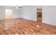 Bright living room with hardwood floors and view of brick fireplace in adjacent room at 4077 Phils Ct, Tucker, GA 30084