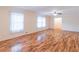 Spacious living room with hardwood floors, crown molding, and white lace curtains at 4077 Phils Ct, Tucker, GA 30084