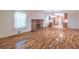 Open concept living room with brick fireplace, hardwood floors, and view into the kitchen at 4077 Phils Ct, Tucker, GA 30084