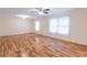 Spacious living room with hardwood floors, ceiling fan, and natural light from the windows at 4077 Phils Ct, Tucker, GA 30084