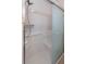 Accessible shower with sliding glass door and safety grab bars for a safe bathing experience at 4077 Phils Ct, Tucker, GA 30084