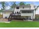 A well-maintained backyard with a deck, covered patio and lush green lawn, perfect for outdoor entertaining at 4555 Holliston Rd, Dunwoody, GA 30360