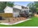 Expansive backyard featuring a wooden fence, lush lawn, patio deck with access to home, and new landscaping at 4555 Holliston Rd, Dunwoody, GA 30360