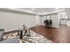Basement rec room featuring wood flooring, area rug, and neutral paint at 4555 Holliston Rd, Dunwoody, GA 30360