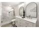 Modern bathroom with marble tiled walk-in shower, dual vanity sinks, and decorative mirrors at 4555 Holliston Rd, Dunwoody, GA 30360
