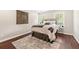 Comfortable bedroom featuring hardwood floors, neutral paint, an area rug and natural lighting at 4555 Holliston Rd, Dunwoody, GA 30360
