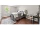 Charming bedroom with hardwood floors, stylish furnishings, and ample natural light at 4555 Holliston Rd, Dunwoody, GA 30360