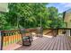 Wooden deck area with rocking chairs and a view of the tree line at 4555 Holliston Rd, Dunwoody, GA 30360