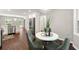 Charming dining area with white table, modern chairs, and bright windows overlooking the backyard at 4555 Holliston Rd, Dunwoody, GA 30360