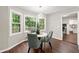 Bright dining area featuring a modern chandelier and large windows with views of the outdoor greenery at 4555 Holliston Rd, Dunwoody, GA 30360