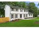 Beautiful two-story home with a well-maintained lawn, white exterior, and dark shutters at 4555 Holliston Rd, Dunwoody, GA 30360