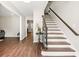 Inviting foyer featuring hardwood floors and a classic staircase with wooden banister and iron spindles at 4555 Holliston Rd, Dunwoody, GA 30360