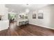 Open-concept kitchen with white cabinets, breakfast bar, and dining area featuring modern lighting fixture at 4555 Holliston Rd, Dunwoody, GA 30360