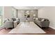 Comfortable living room featuring a decorative accent wall, modern seating, and a stylish coffee table at 4555 Holliston Rd, Dunwoody, GA 30360