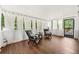 Cozy sunroom with multiple windows, neutral paint, and wood flooring at 4555 Holliston Rd, Dunwoody, GA 30360
