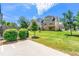 Well-maintained backyard featuring a lush lawn, trees, bushes and a patio in the back of the house at 8295 Village Pl, Suwanee, GA 30024