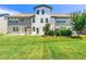 Wide backyard view with a lush lawn and nice landscaping around the back of the house at 8295 Village Pl, Suwanee, GA 30024