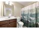 Bathroom with single sink vanity and a bathtub and shower combo with a charming forest curtain at 8295 Village Pl, Suwanee, GA 30024