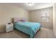 This cozy bedroom features a comfy bed, bedside table and ample natural light from the window at 8295 Village Pl, Suwanee, GA 30024