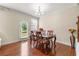 Formal dining area with hardwood floors, chair rail, and views of the backyard at 8295 Village Pl, Suwanee, GA 30024
