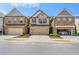 Beautiful brick townhome with two car garage and manicured landscaping at 8295 Village Pl, Suwanee, GA 30024