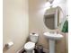 Neat half bathroom features pedestal sink, oval mirror, and neutral wall paint at 8295 Village Pl, Suwanee, GA 30024