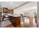 Open concept kitchen features granite island, stainless appliances, and hardwood floors at 8295 Village Pl, Suwanee, GA 30024