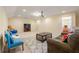 Spacious living room with comfortable seating, neutral carpet, and a projector and screen at 8295 Village Pl, Suwanee, GA 30024