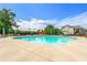 Community pool surrounded by lounge chairs and umbrellas, offering a relaxing outdoor experience at 8295 Village Pl, Suwanee, GA 30024