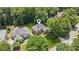Aerial shot showcasing a beautiful home nestled amongst mature trees in a quiet neighborhood at 1140 River Laurel Dr, Suwanee, GA 30024