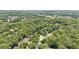 Aerial view of the property and the surrounding wooded neighborhood at 1140 River Laurel Dr, Suwanee, GA 30024