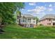 Large backyard with lush green lawn and a view of the home's back exterior at 1140 River Laurel Dr, Suwanee, GA 30024
