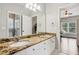 Double vanity bathroom with granite countertops, white cabinets, and large mirror to enhance the space at 1140 River Laurel Dr, Suwanee, GA 30024