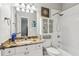 Well-lit bathroom with granite countertops, a tub-shower combo, and decorative nautical accents at 1140 River Laurel Dr, Suwanee, GA 30024